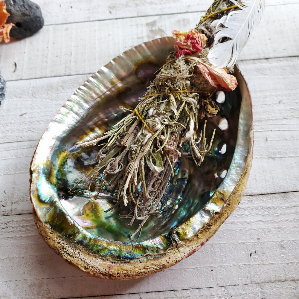 a bowl filled with dried herbs and herbs