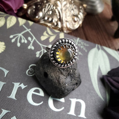a ring with a stone on top of it