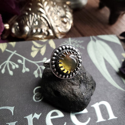 a ring with a yellow stone on top