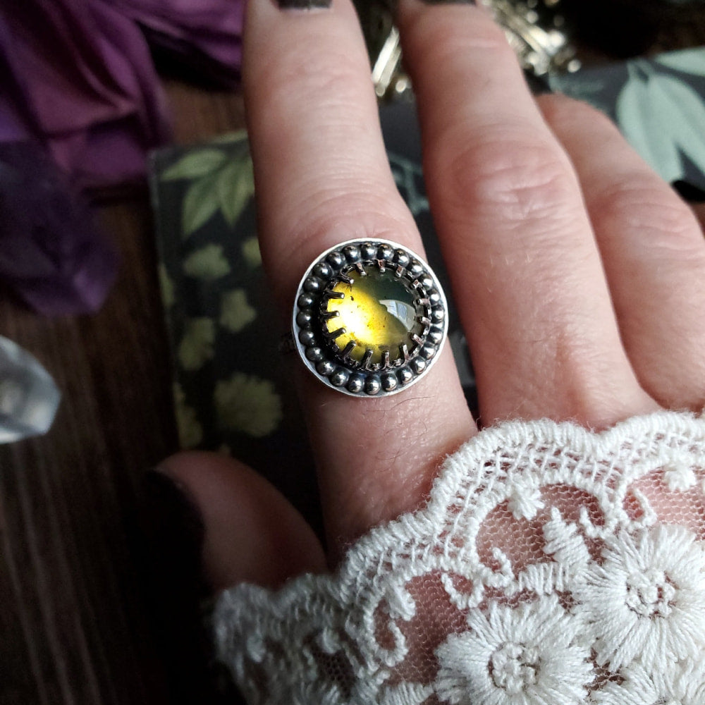 a person wearing a ring with a yellow stone