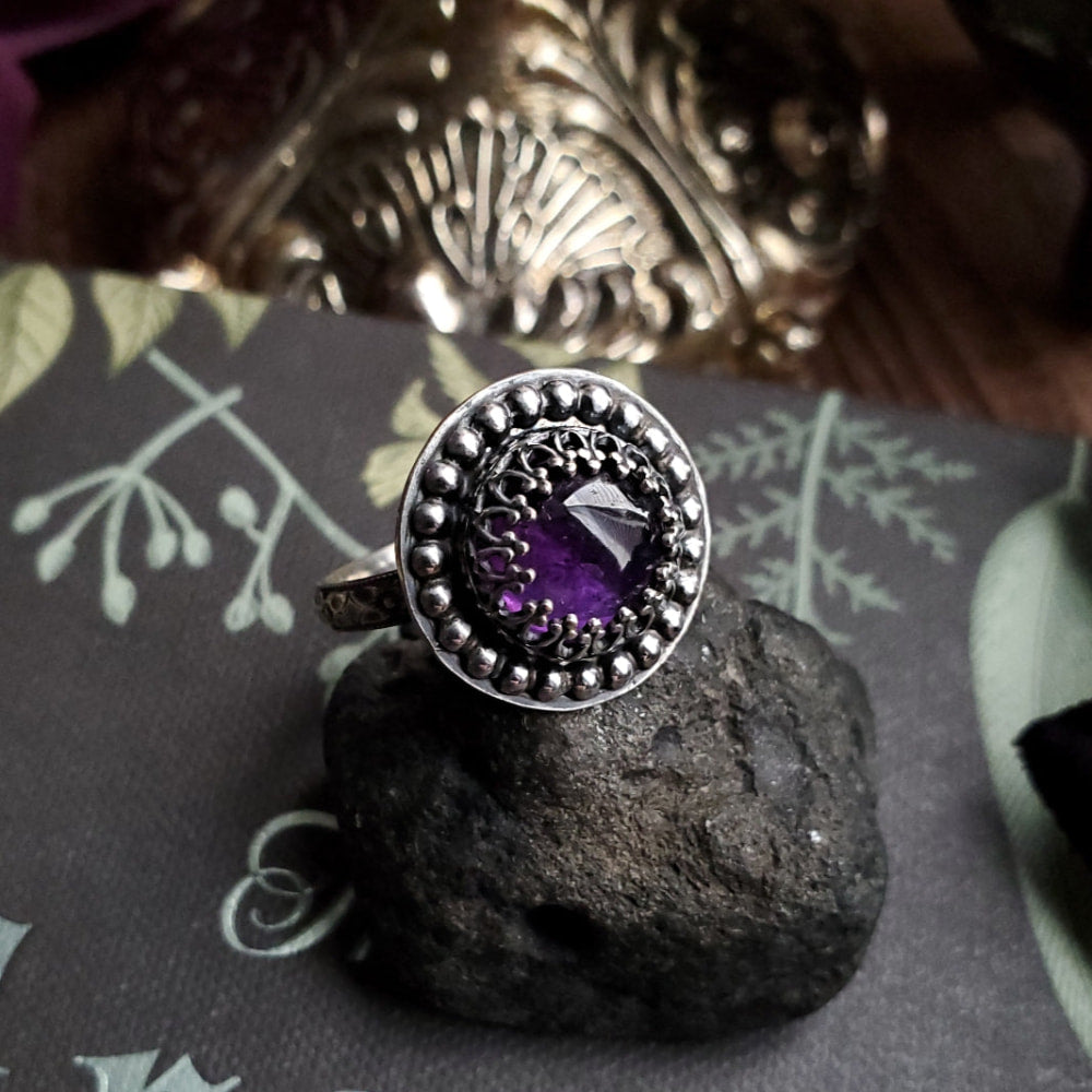a ring with a purple stone on top