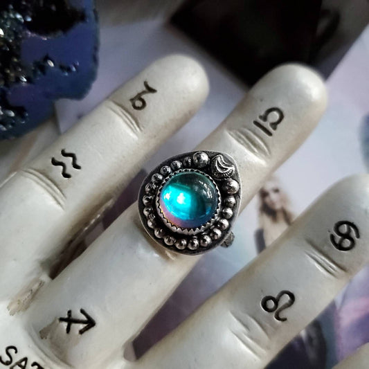 a ring with a blue stone in it