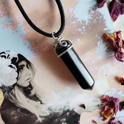 a black necklace with a photo of a woman on it