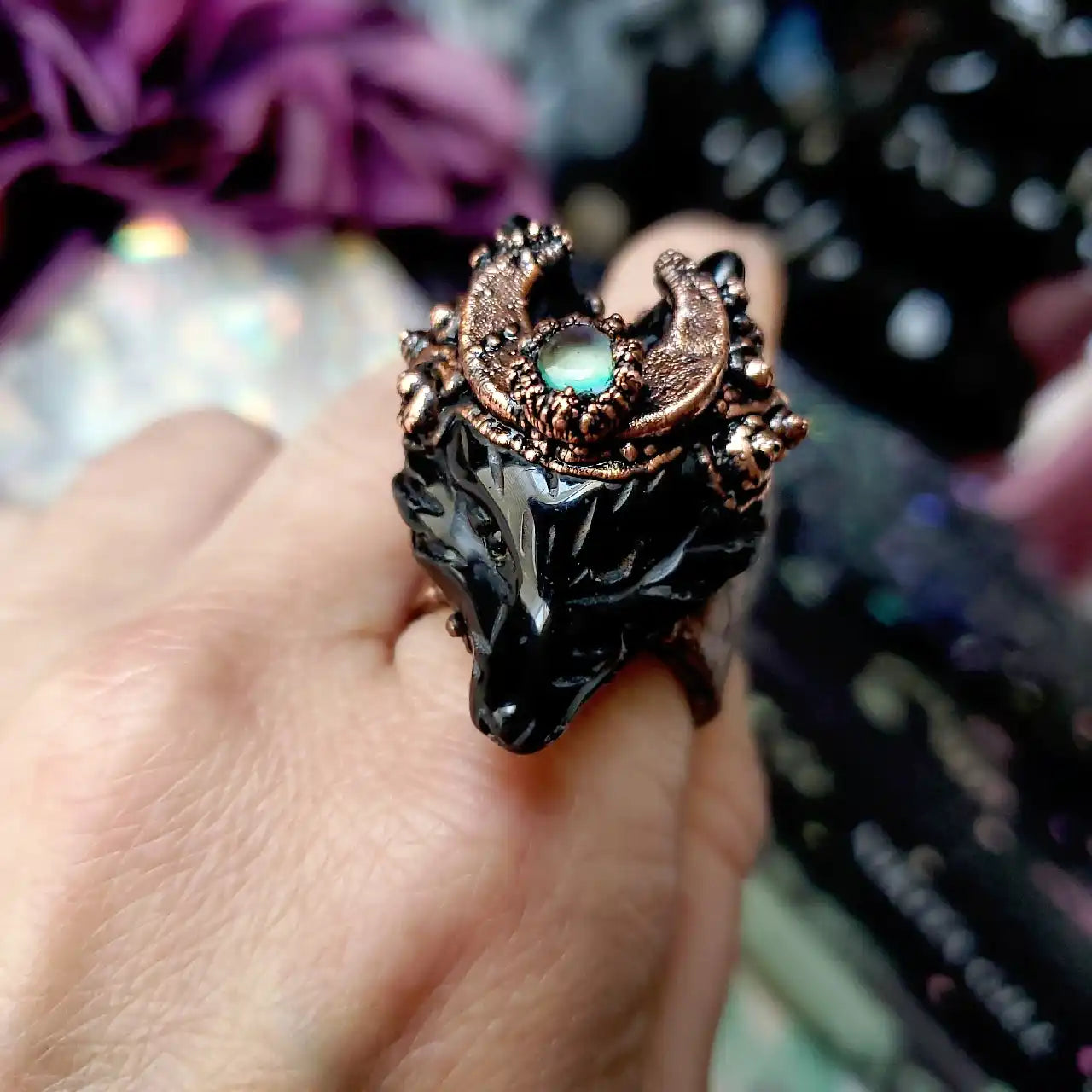 A wolf moon ring with tiny quartz crystal.