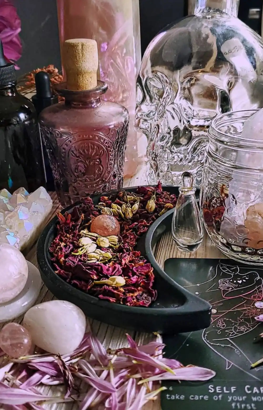 Crescent-shaped bowl filled with dried flowers and herbs.