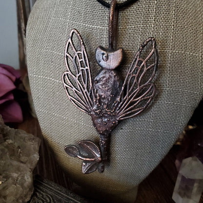 a necklace with a bird on it
