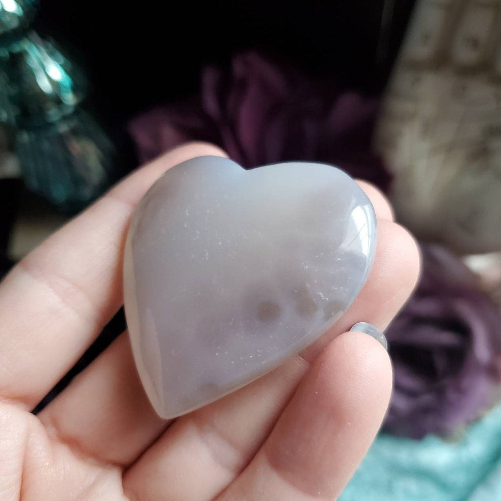 a heart shaped stone in someone’s hand