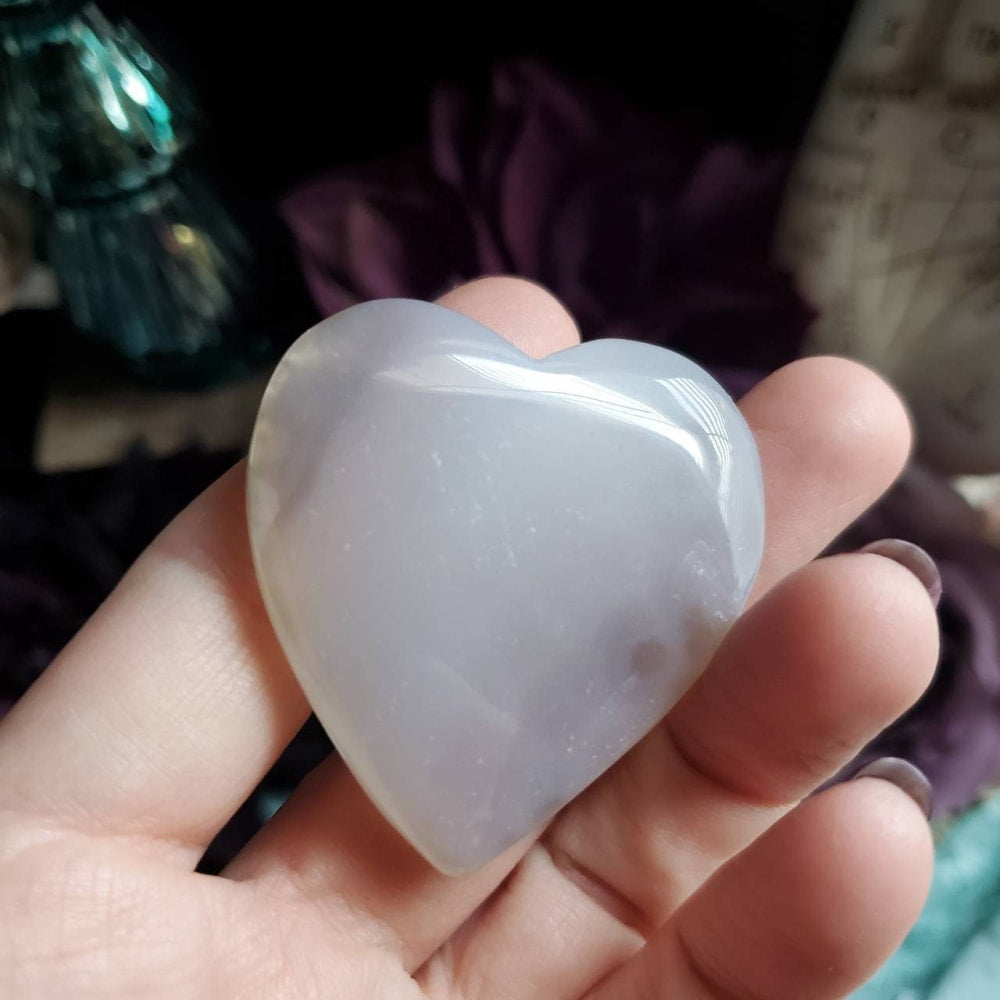 a person holding a white heart shaped object