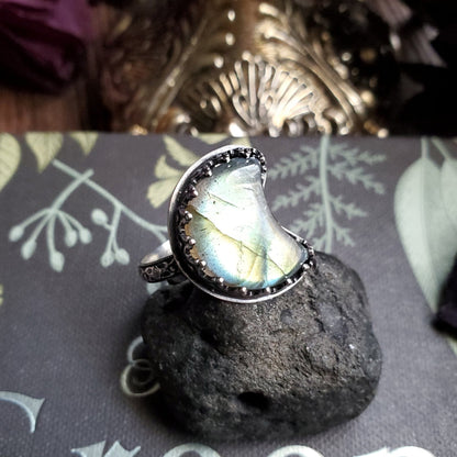 a ring with a rainbow colored stone on top