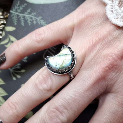 a woman’s hand with a ring on it