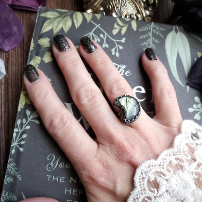 a woman’s hand with a black and white manicure