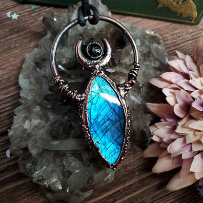 a blue stone pendant on a wooden table