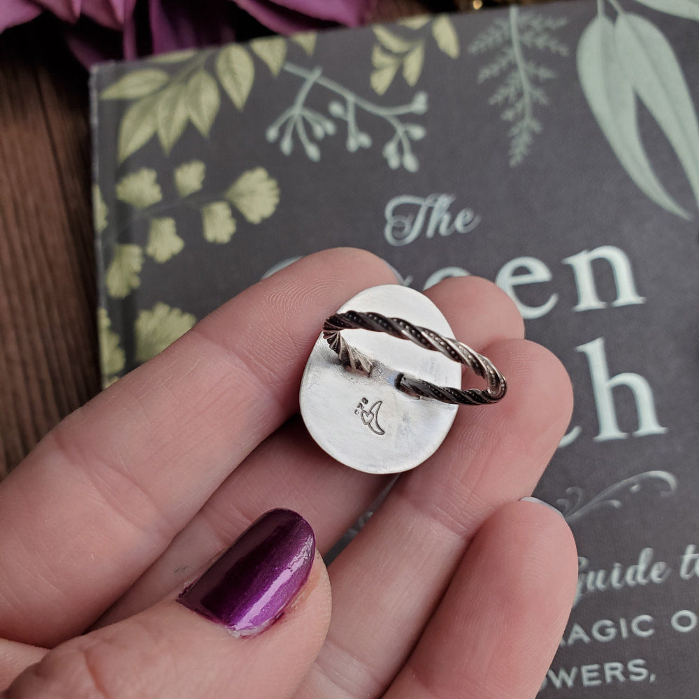 a person holding a ring with a heart on it