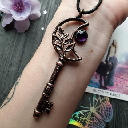 a handmade key bracelet with a purple stone