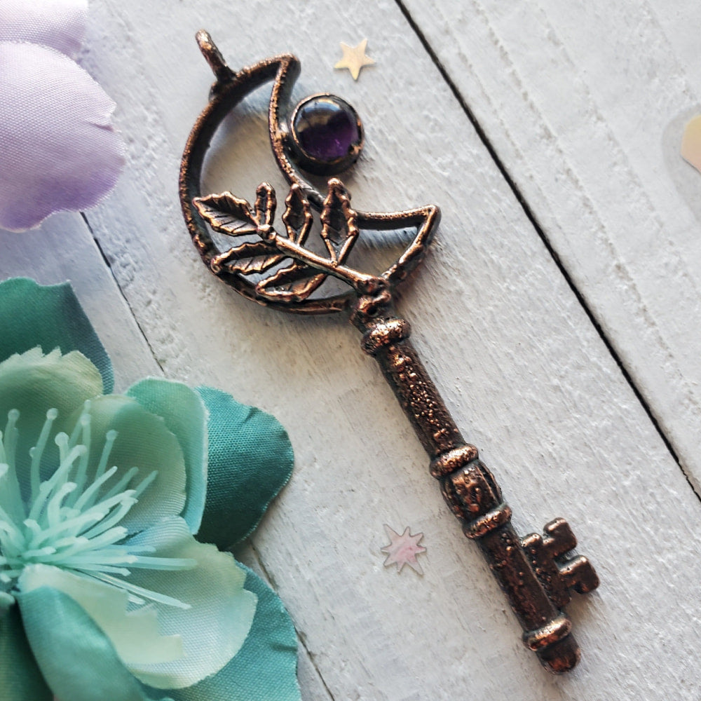 a key with a flower and a keyring