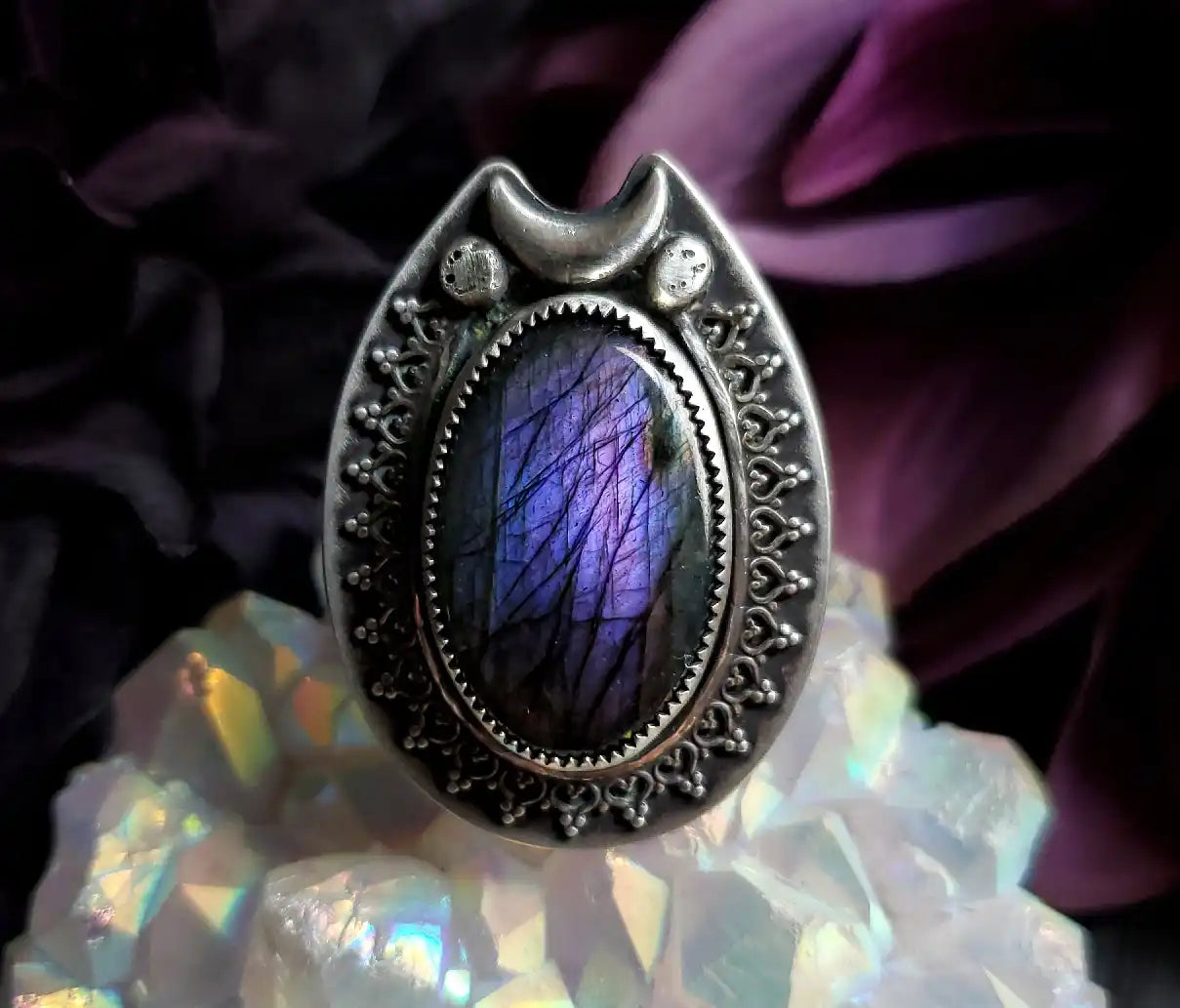 Silver ring with purple stone.