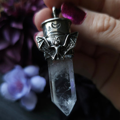 Crystal pendant with an ornate metal bat-themed cap.