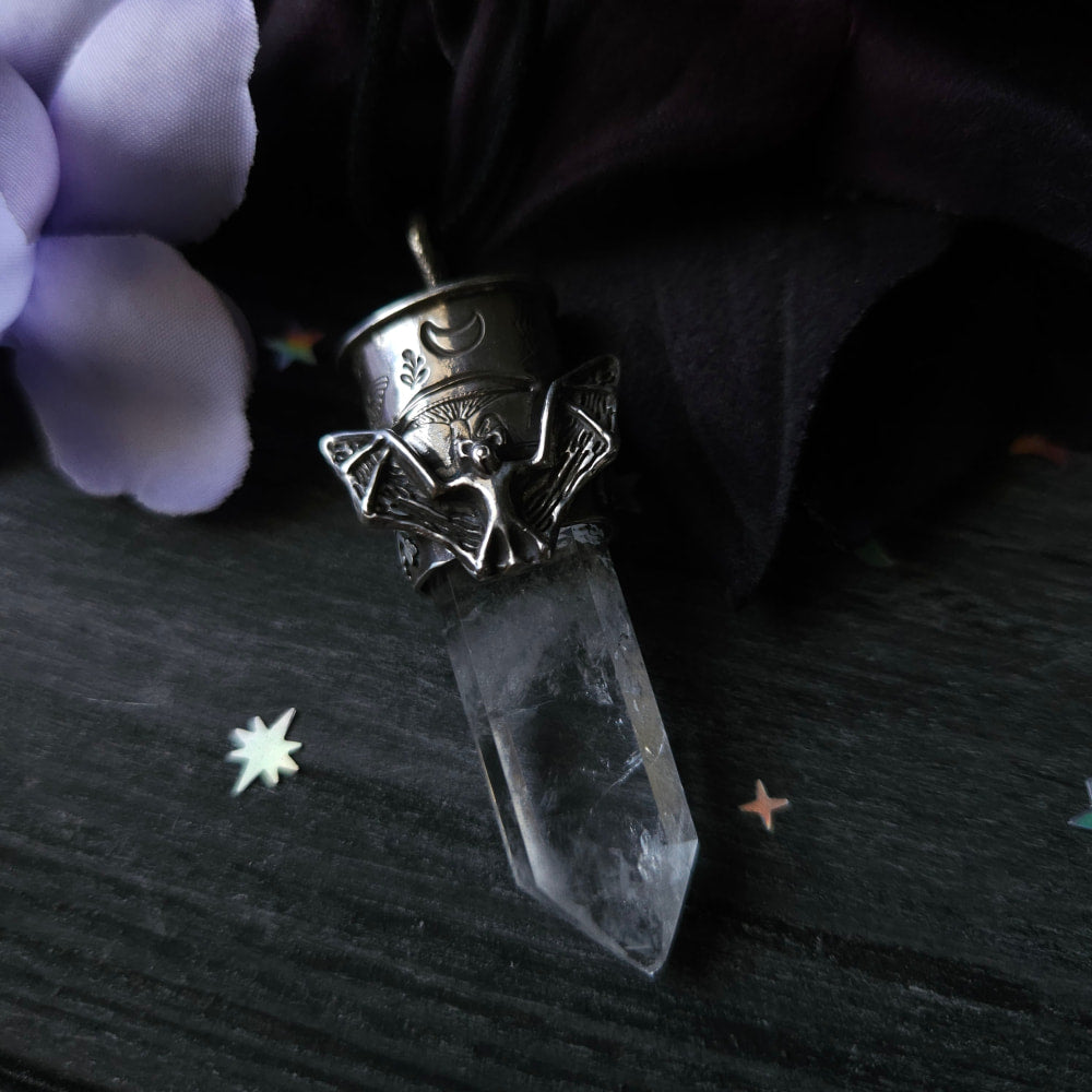 Crystal pendant with an ornate metal cap featuring bat-like designs.