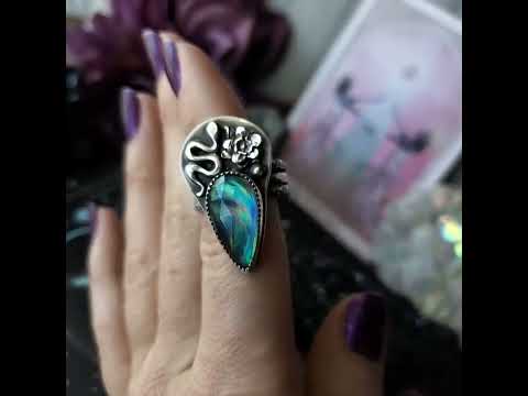 Pretty snake ring with flower and blue crystal.